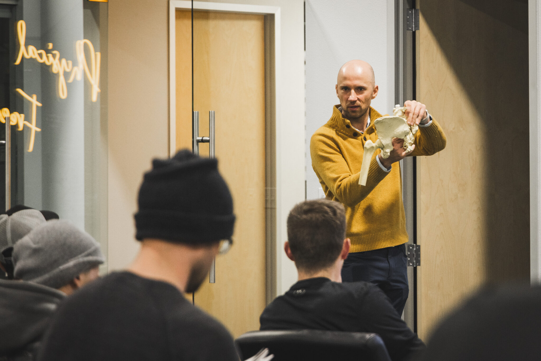 Zac Cupples presenting at a seminar using an articulating pelvis model
